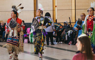 Indigenous performers in costume.
